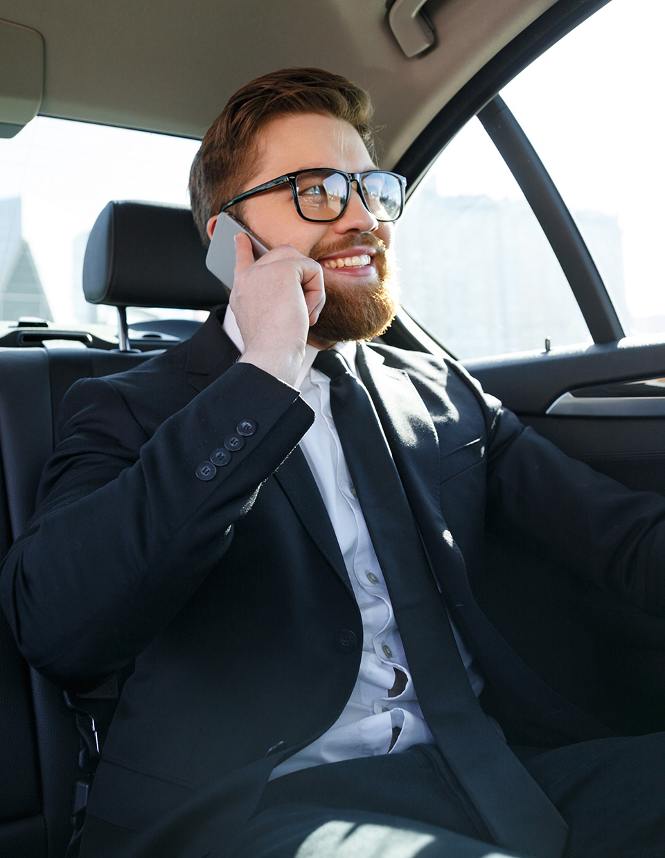 man calling inside a black limo