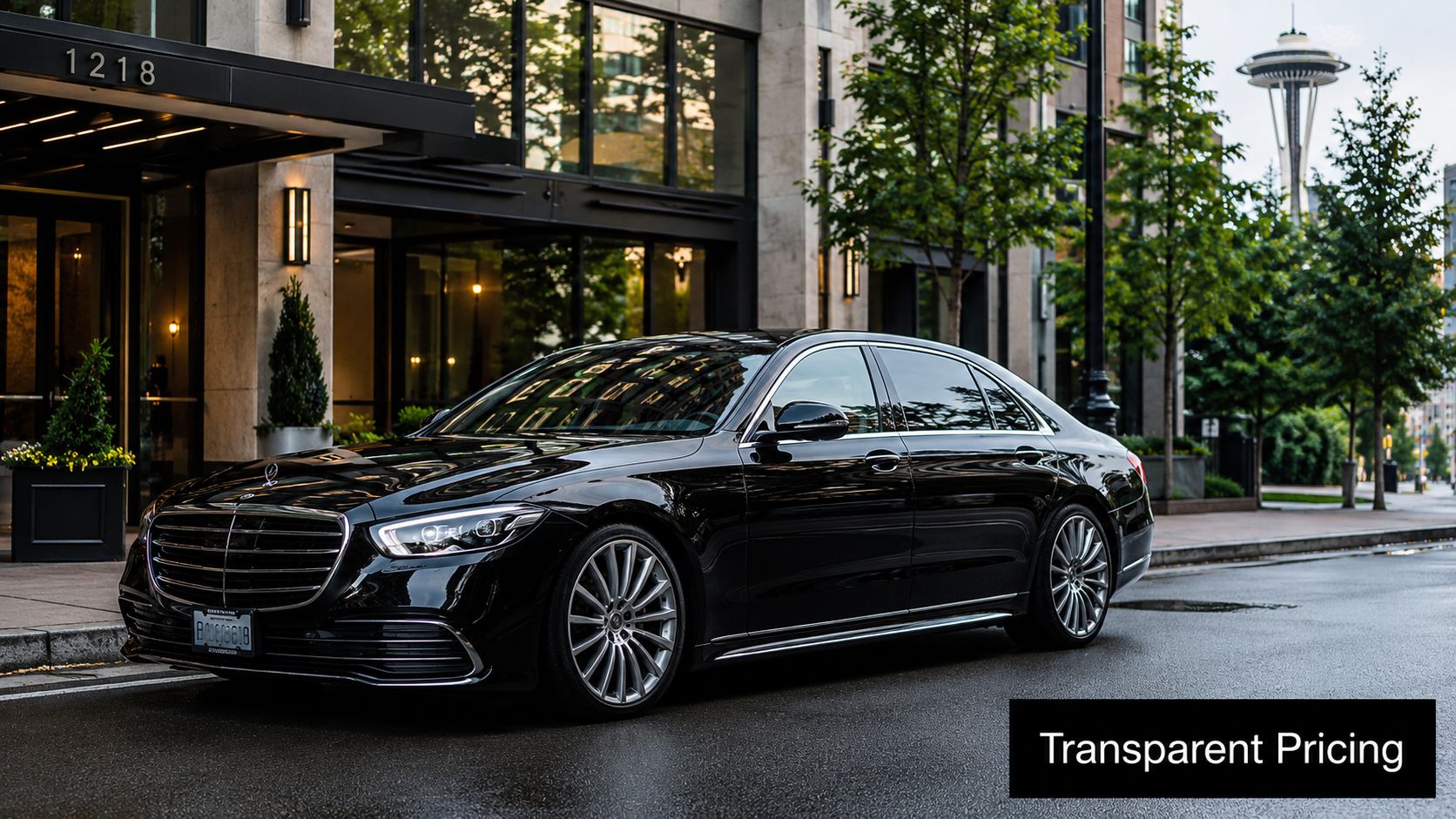 A sleek black Mercedes-Benz limousine parked in front of a modern building with a city skyline view.
