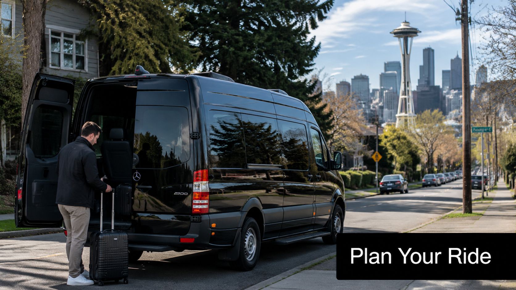 A man loading luggage into a luxury black sprinter van in front of the Seattle Space Needle.