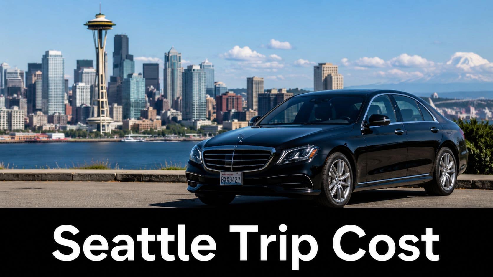 A black Mercedes-Benz sedan parked overlooking the Seattle skyline with the Space Needle visible in the background.